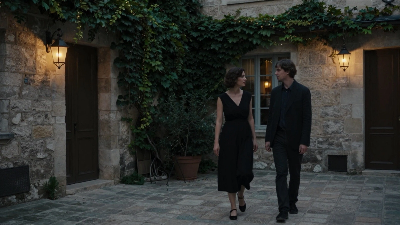 A woman and client walking through a quiet courtyard in Le Marais at dusk, engaged in quiet conversation.